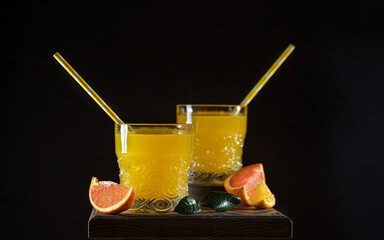 Glass of fresh orange juice with fresh fruit on a wooden table Still life with fresh orange juice...