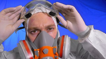 Scientist virologist in respirator. Slow motion. Man close up look, wearing protective medical...