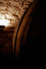 wooden wine barrels in an old historic cellar basement