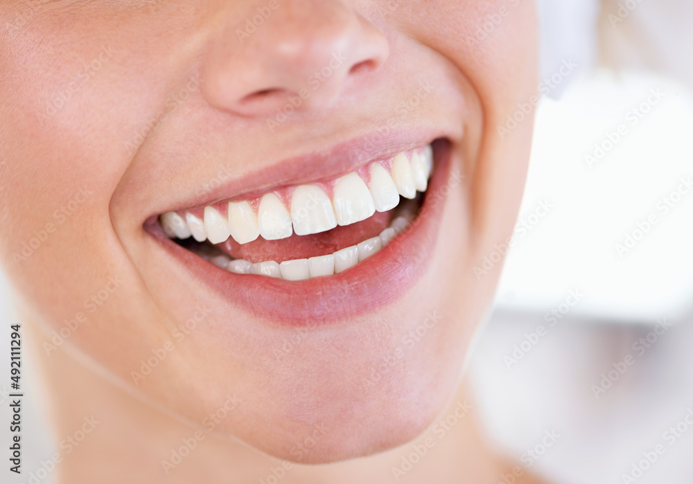 Wall mural A brilliant display of pearly whites. Close up of a womans sparkling teeth.