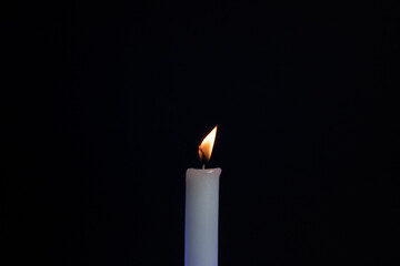 Fototapeta premium candle in the dark. candle on a black background. Fire candles on a black background
