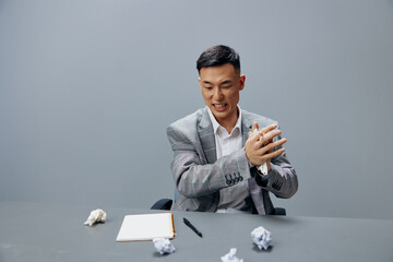 Asian man in a gray suit crumpled paper office official emotions Lifestyle