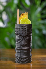 Tropical tiki cocktail on a wooden table