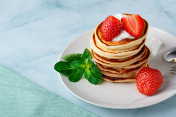 Stack of pancakes with fresh strawberry