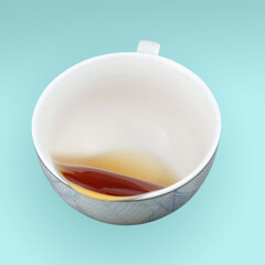 A falling teacup with pouring tea
