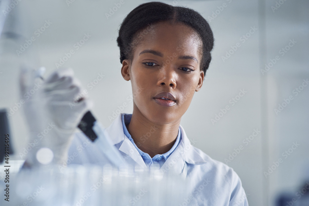 Poster Ensuring the cure is up to standard. Shot of a young scientist working in a lab.