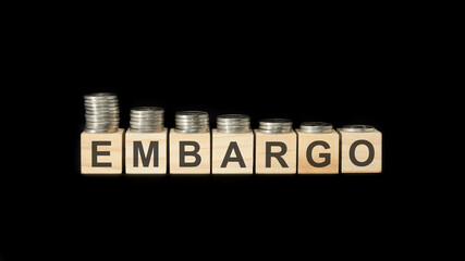 embargo - word of wooden blocks with letters on a black background. selective focus.