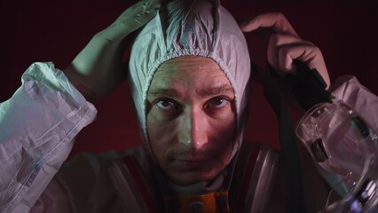Man in protective costume suit, gas protect medical antibacterial antiviral spray paint mask....