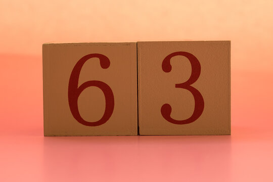 Numbers or dates on wooden cubes, sixty-three
