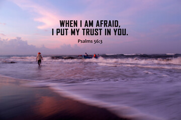 Bible verse inspirational quote - When i am afraid, i put my trust in You. Psalms 56:3 With fisherman working at sea. On sunrise beach background. Believe and surrender to God concept. Christianity.  - obrazy, fototapety, plakaty
