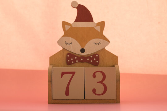Numbers or dates on wooden cubes with fox, seventy-three