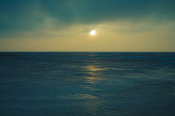 Frozen shore of the Kiev Sea at sunset