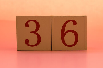 Numbers or dates on wooden cubes, thirty-six