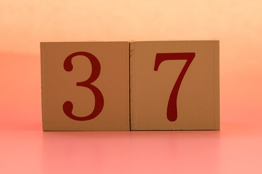Numbers or dates on wooden cubes, thirty-seven