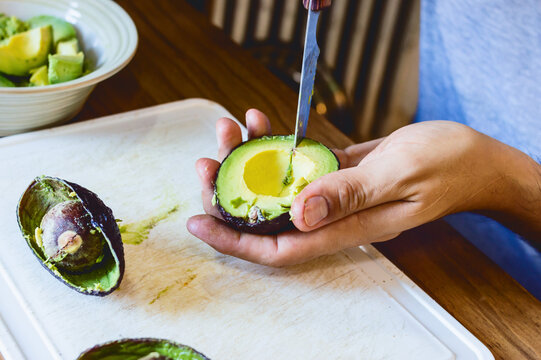 Detail Of Caucasian Male Hands Peeling An Avocado