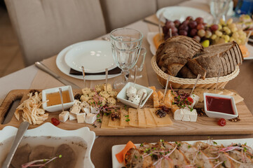 Wedding buffet. Slicing different types of cheese. Catering
