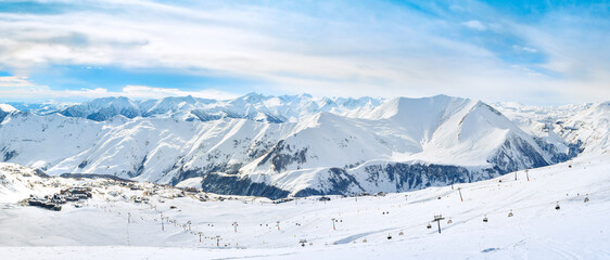 Gudauri ski resort panoramic view with snowy peaks and new Gudauri village background in winter...