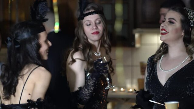 People dressed in style of Roaring twenties having fun on Gatsby party. Vintage, retro party, fashion, girls friends concept