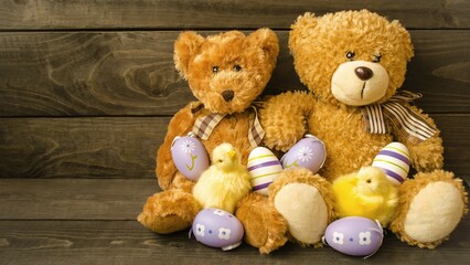 Obraz premium Decorative postcard, soft fluffy teddy bears with Easter eggs and yellow little chickens sit on a wooden background. Concept holiday bright easter, minimalism. Space for copy text.