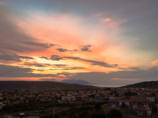 Fototapeta premium a seaside town between two mountains wit sea gull flight or an island in the Aegean, Gokceada, Imbros, turkey, clouds, sky 