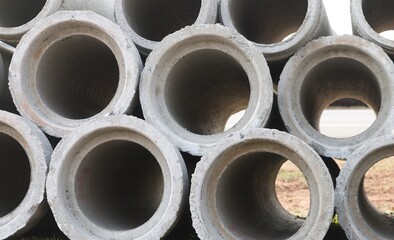 Macro view of concrete pipes stacked up high.