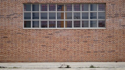 Fototapeta na wymiar sidewalk with brick industrial facade