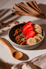Strawberry yogurt with granola, sliced ​​strawberries and bananas