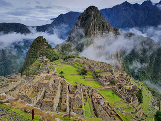 Machu Picchu, the old Inca settlement with the picturesque background nature covered partly in...