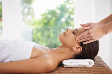 Obraz na płótnie Canvas Healing hands. A young woman receiving a face massage.