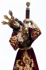 Obraz premium Procession of Jesus in the Holy Week of Spain, Andalusia, Granada. Holy week in seville. Painful face of crucified christ with cross on his back. phot vertical