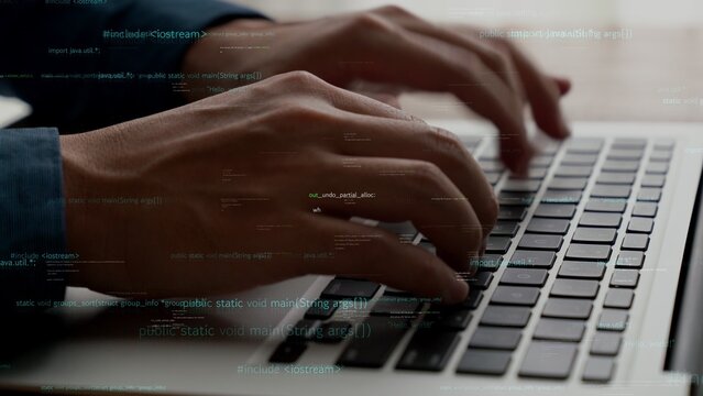 Computer programmer uses capable laptop computer to develop programming code of new software . Computer specialist working on future coding application for software programming development .