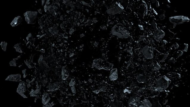 Super slow motion shot of rotating exploded scattered coal on black at 1000fps.