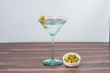 gin cocktail with lemon and olives 