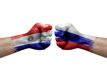 Two hands punch to each others on white background. Country flags painted fists, conflict crisis concept between paraguay and russia