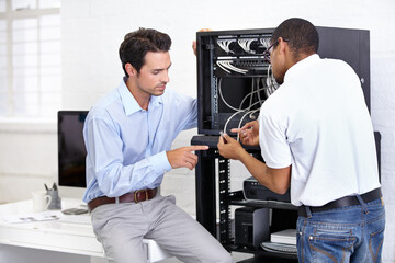 Never fear when the IT guy is near. A young IT specialist ready to fix a server.