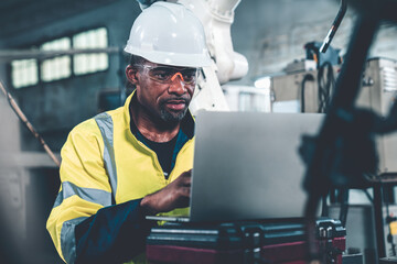 Factory worker working with laptop computer to do adept procedure checklist . Factory production...