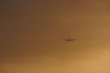 Silhouette of airplane in evening sky