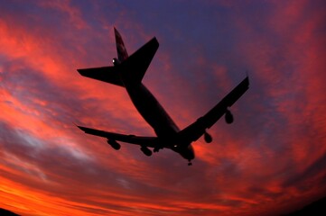 Silhouette of airplane in evening sky