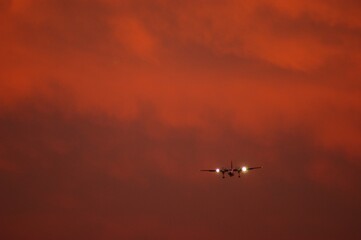 Silhouette of airplane in evening sky