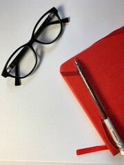 glasses and pen on a notebook