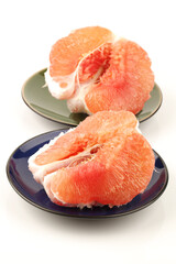 peeled pomelo pieces isolated on white background. Tasty fresh fruit eating concept