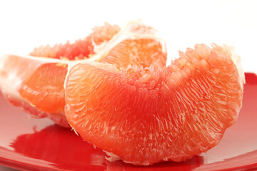 peeled pomelo pieces  background. Tasty fresh fruit eating concept
