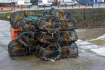 Fototapeta na wymiar Lobster Pots stacked on the quayside in the popular fishing village of Ardglass