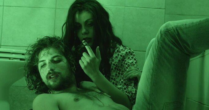 drug, high - stoned junkie couple lying on the floor in the bathroom