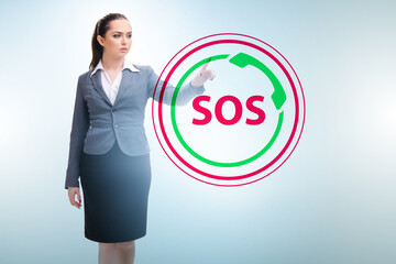 Businesswoman pressing SOS button in case of danger