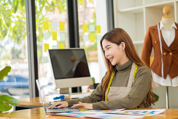 portrait of a beautiful woman Stylish designer fashion designers stand and work with colorful...