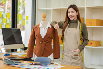 portrait of a beautiful woman Stylish designer fashion designers stand and work with colorful...