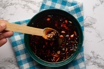 Chili oil sauce with sesame and peanuts called macha. Mexican food - obrazy, fototapety, plakaty