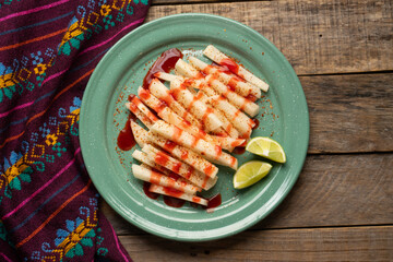 Mexican yam bean also called Jicama with chili powder and chamoy sauce