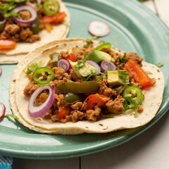 Ground beef tacos with avocado and bell peppers. Mexican food